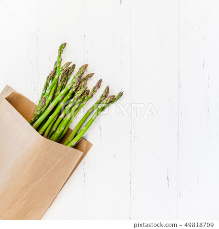 Fresh green asparagus on white wooden background Fresh green asparagus on white wooden background 49818709
