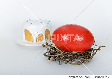 The nest with big red painted ostrich easter egg The nest with big red painted ostrich easter egg 49820947