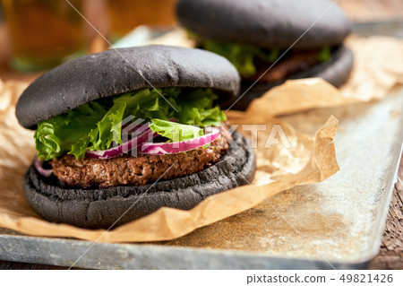 Dirty black burgers closeup Dirty black burgers closeup 49821426