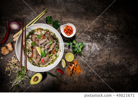Pho bo asian food background with various ingredients on rustic stone background , top view. Pho bo asian food background with various ingredients on rustic stone background , top view. 49821671