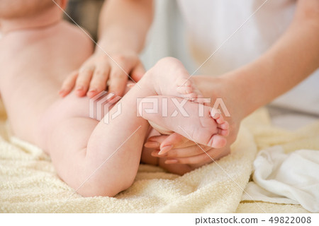 Famel hands massage gently baby, close up 49822008