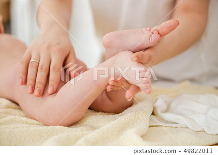 Young woman massage gently baby, close up 49822011