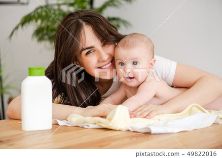 Portrait of mother and infant with lotion Portrait of mother and infant with lotion 49822016