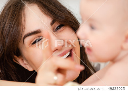 Smiling woman mom look at baby infant 49822025