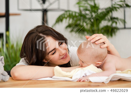 Mother smile caress touch baby girl head 49822029