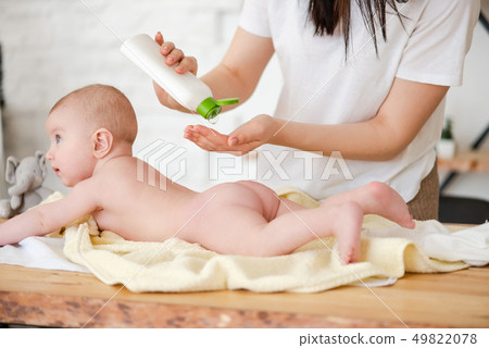 Mother put oil lotion at baby skin Mother put oil lotion at baby skin 49822078