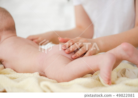 Young mother caress touch baby soft skin 49822081