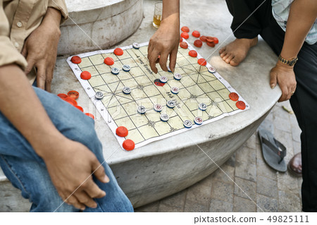 Gamers playing traditional asian chess outdoors in Hanoi 49825111