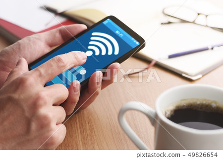 Up of the male hand to set the WiFi of the smartphone. 49826654
