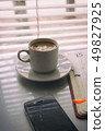 Silhouettes of sunrise morning coffee with a note and telephone 49827925