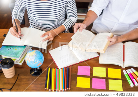 Young students classmates help friend catching up 49828338