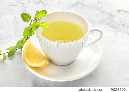 A photo of a cup of tea with lemon and mint with copy space A photo of a cup of tea with lemon and mint with copy space 49828802