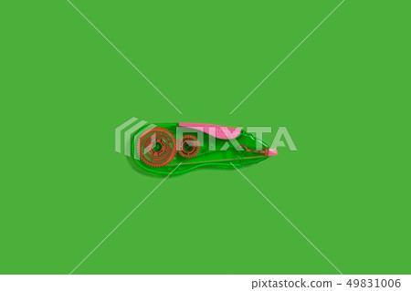 tape corrector on a green background 49831006