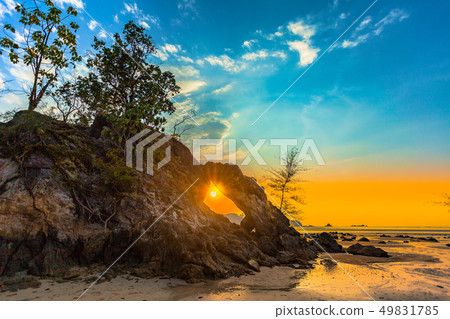 light through in the hole of unusual rock 49831785