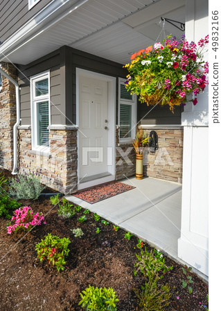 Entrance of brand new townhome decorated with flowers. 49832166
