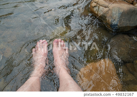Man Relaxing His Feet in the Cold and Fresh. 49832167