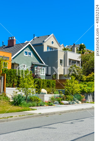 Modern residential houses on the street with landscaped front yards on terraces. Modern residential houses on the street with landscaped front yards on terraces. 49832324