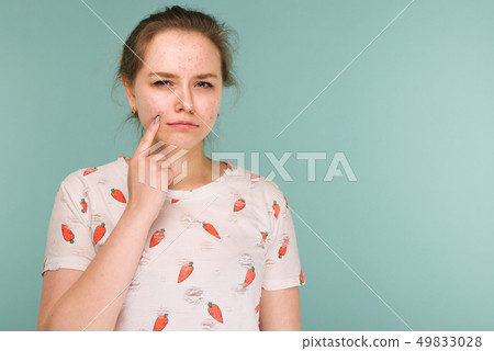 Portrait of teen girl touching her face and 49833028