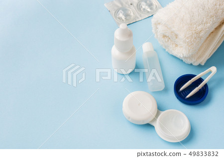 Contact lenses, tweezers and a container Contact lenses, tweezers and a container 49833832