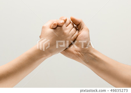Two male hands competion in arm wrestling isolated on grey studio background Two male hands competion in arm wrestling isolated on grey studio background 49835273