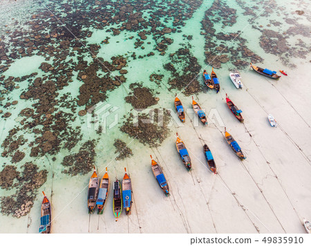 Wooden long-tail boats anchor on coastline with 49835910