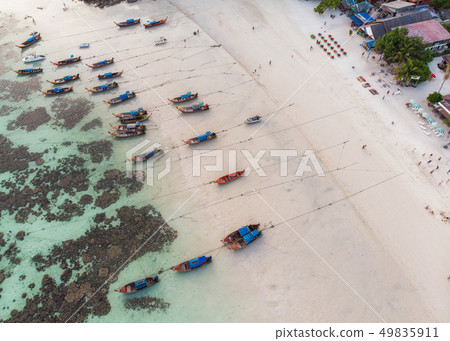 Wooden long-tail boats anchor on coastline with 49835911