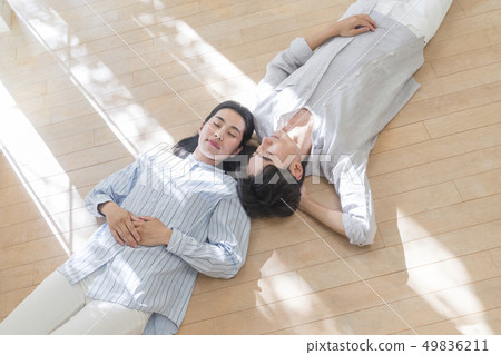 Couple sleeping on the floor 49836211