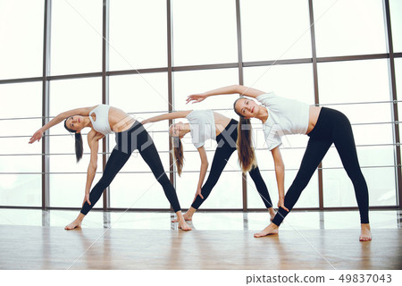 Beautiful and elegant girls doing yoga 49837043