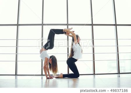 Beautiful and elegant girls doing yoga Beautiful and elegant girls doing yoga 49837186