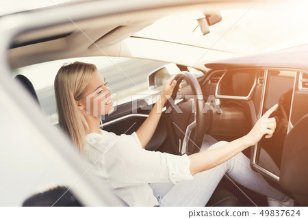 A young girl presses buttons on electric vehicle A young girl presses buttons on electric vehicle 49837624