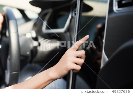 A young girl presses buttons on electric vehicle A young girl presses buttons on electric vehicle 49837626