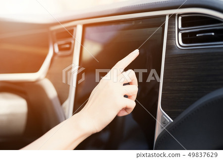 A young girl presses buttons on electric vehicle 49837629