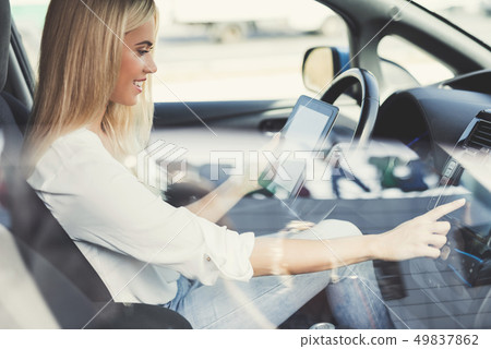 A young girl presses buttons on electric vehicle A young girl presses buttons on electric vehicle 49837862