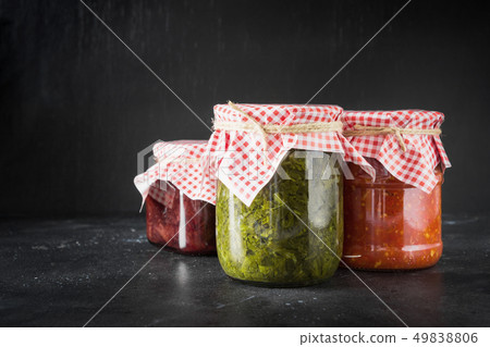 Various types of canned sauce for serving to meat, adjika from tomato, sorrel, tkemali from plum. Various types of canned sauce for serving to meat, adjika from tomato, sorrel, tkemali from plum. 49838806