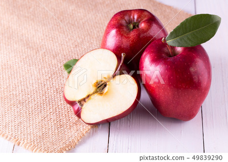 Red apples with leaves on the table Red apples with leaves on the table 49839290