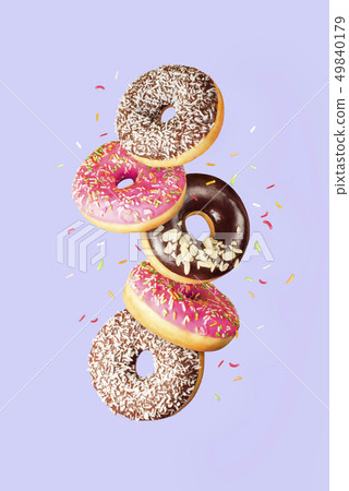 Sweet and colourful doughnuts falling or flying in Sweet and colourful doughnuts falling or flying in 49840179