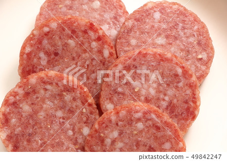 A round slice of salami (soft salami). A round slice of salami (soft salami). 49842247