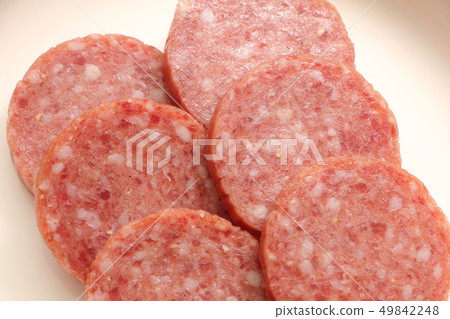 A round slice of salami (soft salami). A round slice of salami (soft salami). 49842248