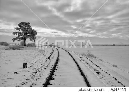 Single railway track in winter landscape. Single railway track in winter landscape. 49842435