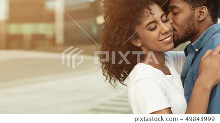 Man kissing girlfriend, enjoying date in the city Man kissing girlfriend, enjoying date in the city 49843999