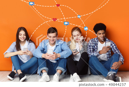 Friends chatting in social networks, using phones 49844237