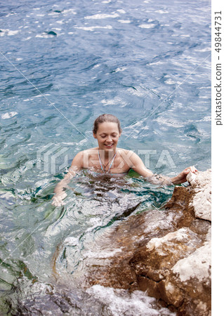 Portrait woman relax luxury pool villa, infinity sea view. Rest and travel. On a Sunny summer day. Portrait woman relax luxury pool villa, infinity sea view. Rest and travel. On a Sunny summer day. 49844731