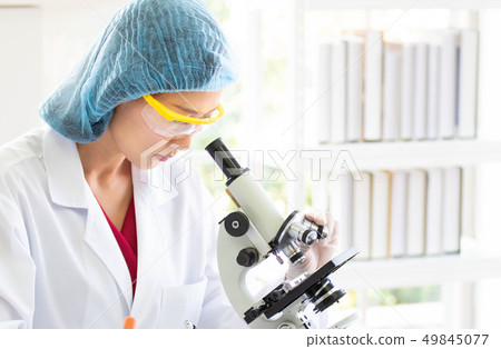 Scientists are looking at the microscope. Scientists are looking at the microscope. 49845077