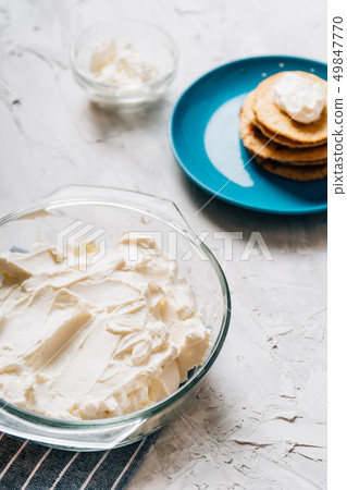 Bowl of cream cheese homemade in glass plate with pancakes and cottage cheese vertical healthy food Bowl of cream cheese homemade in glass plate with pancakes and cottage cheese vertical healthy food 49847770
