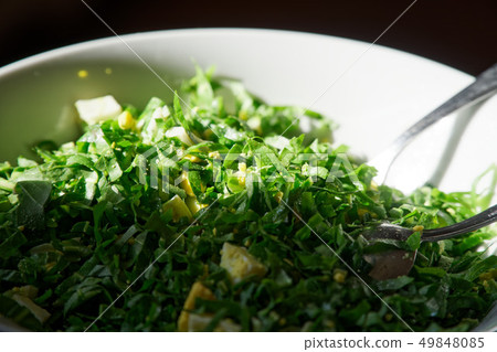 Salad with boiled egg and fresh spinach on plate 49848085