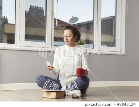 Young woman sending text message Young woman sending text message 49848124
