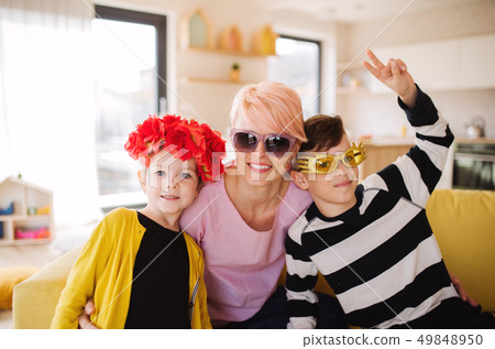 A young mother with two children having fun at home. A young mother with two children having fun at home. 49848950
