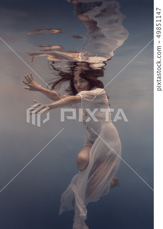 Portrait of a girl in a white dress under water Portrait of a girl in a white dress under water 49851147