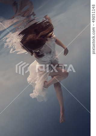 Portrait of a girl in a white dress under water Portrait of a girl in a white dress under water 49851148