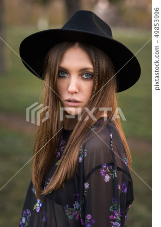 Beautiful brunette in casual wear and hat. 49853996